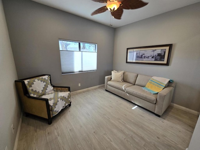 living room with ceiling fan and light wood-type flooring