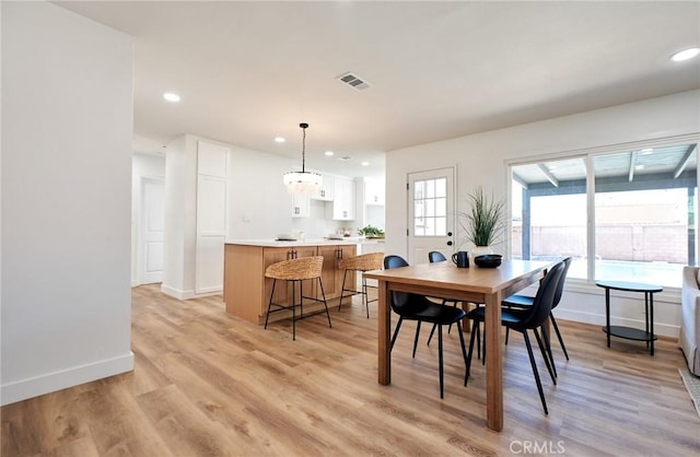 dining space with light hardwood / wood-style floors