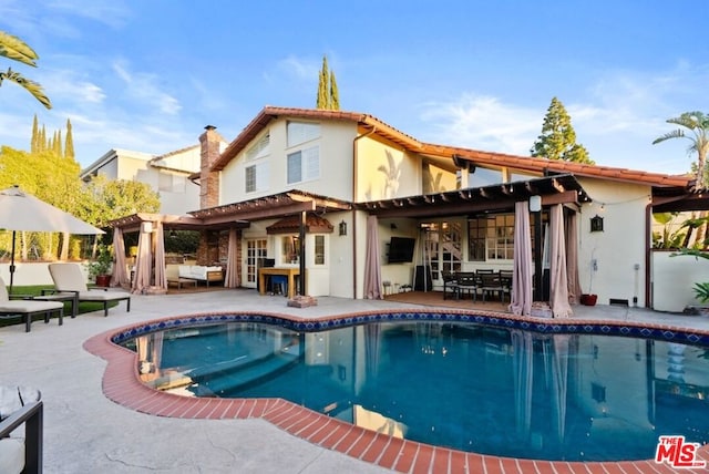 rear view of house featuring outdoor lounge area, a pergola, and a patio