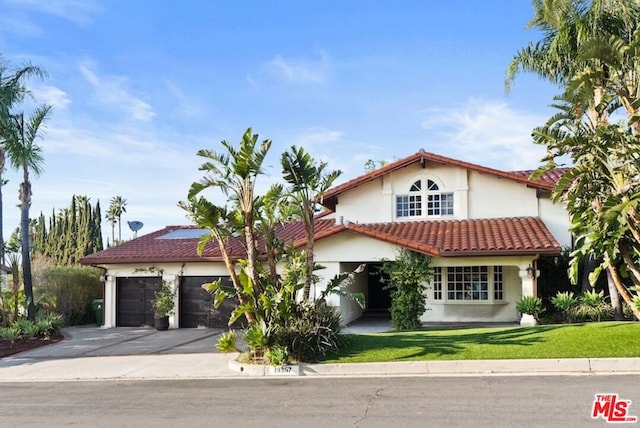 mediterranean / spanish home with a garage