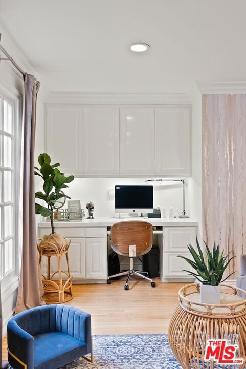 office space featuring built in desk and light wood-type flooring