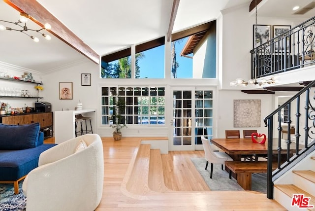 living room with hardwood / wood-style flooring, crown molding, high vaulted ceiling, and beamed ceiling