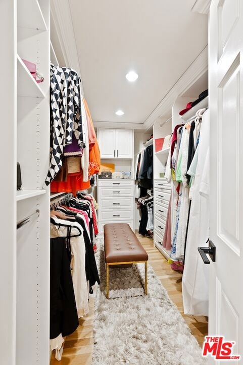 spacious closet with light hardwood / wood-style floors