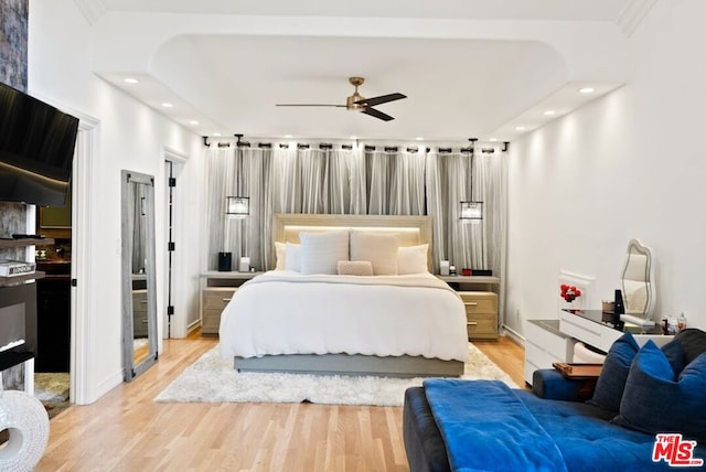 bedroom with ceiling fan and light hardwood / wood-style floors