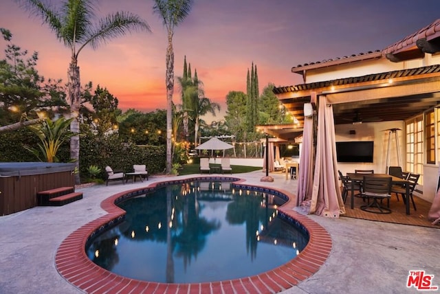 view of pool featuring a hot tub and a patio