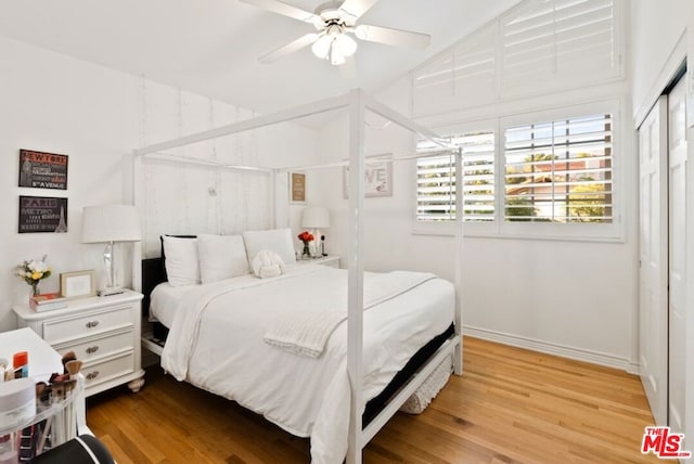 bedroom with ceiling fan, light hardwood / wood-style floors, and a closet