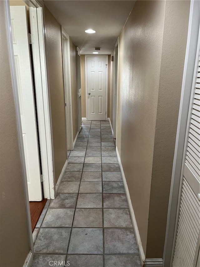 corridor with dark tile patterned floors