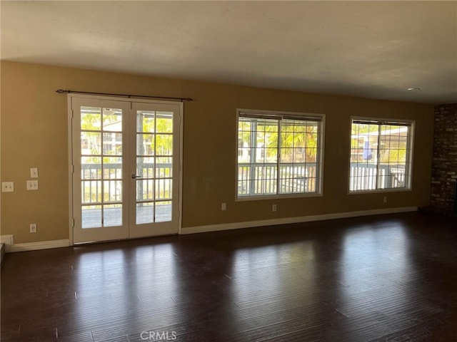 unfurnished room with dark hardwood / wood-style flooring and french doors