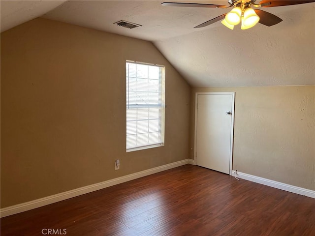 bonus room featuring vaulted ceiling, ceiling fan, and dark hardwood / wood-style flooring