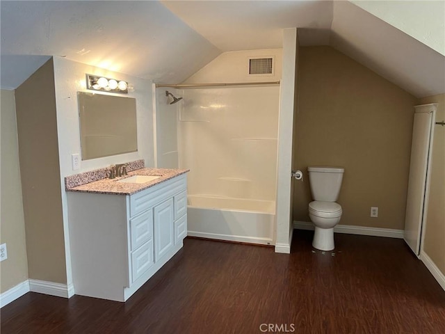 full bathroom featuring lofted ceiling, hardwood / wood-style floors, and toilet