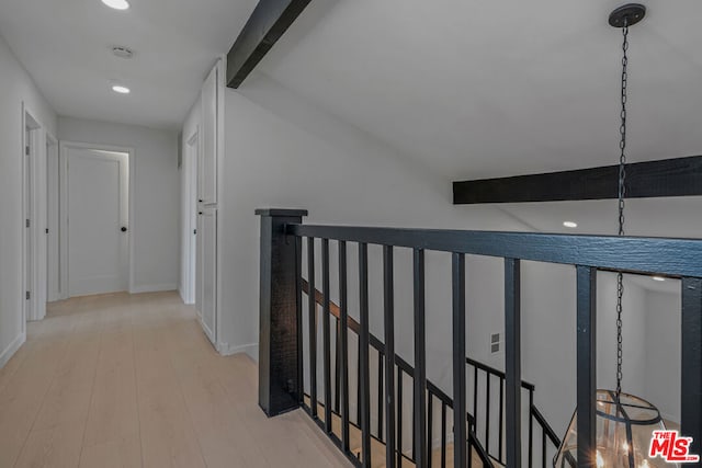 hall featuring beamed ceiling and light hardwood / wood-style floors