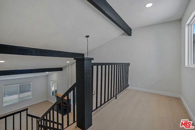 stairs featuring wood-type flooring and lofted ceiling with beams