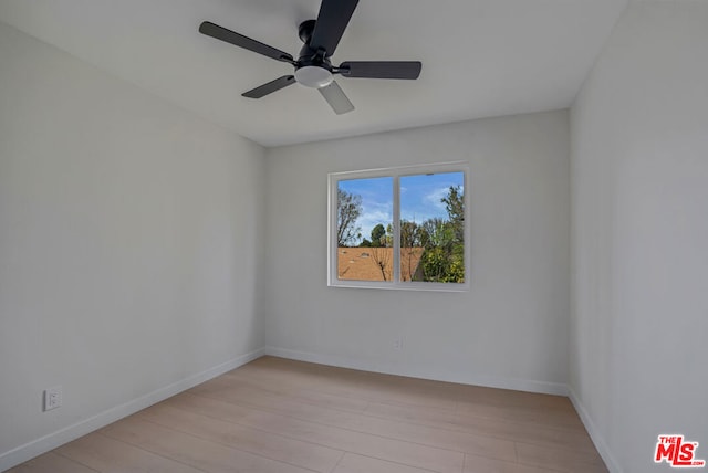 spare room featuring ceiling fan and light hardwood / wood-style flooring