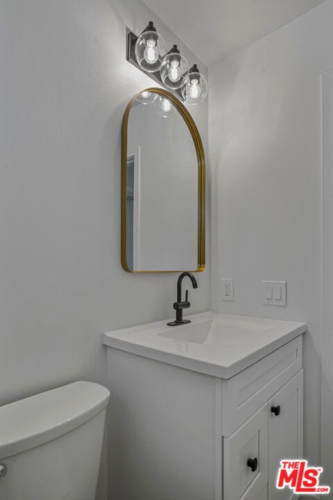 bathroom with vanity and toilet