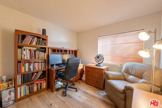 office area with light hardwood / wood-style floors