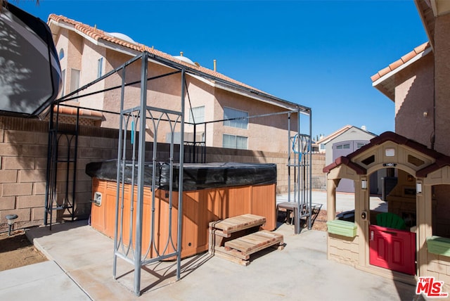 exterior space with a hot tub