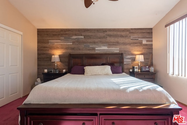 bedroom with wooden walls and ceiling fan