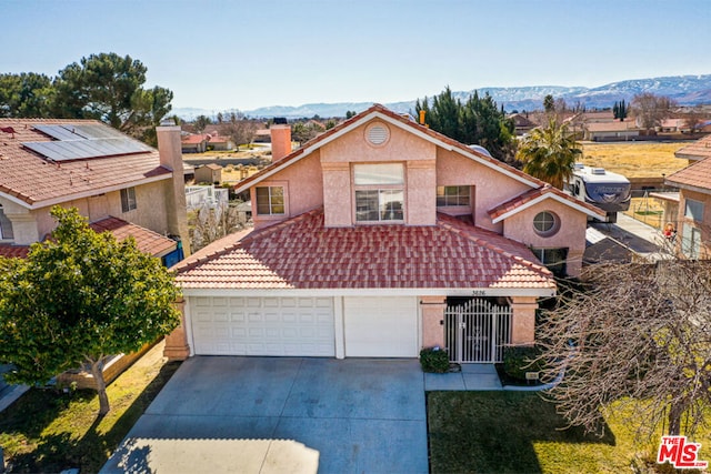 front facade featuring a garage and a mountain view