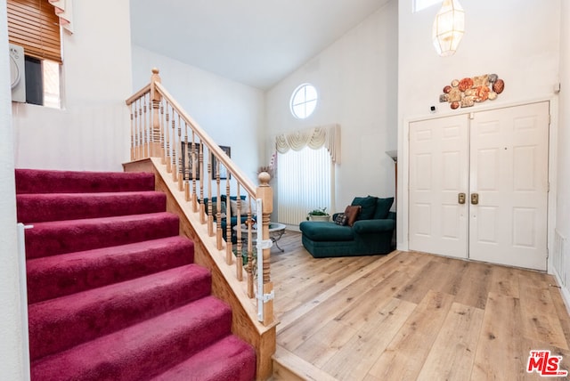 entrance foyer featuring high vaulted ceiling and hardwood / wood-style floors