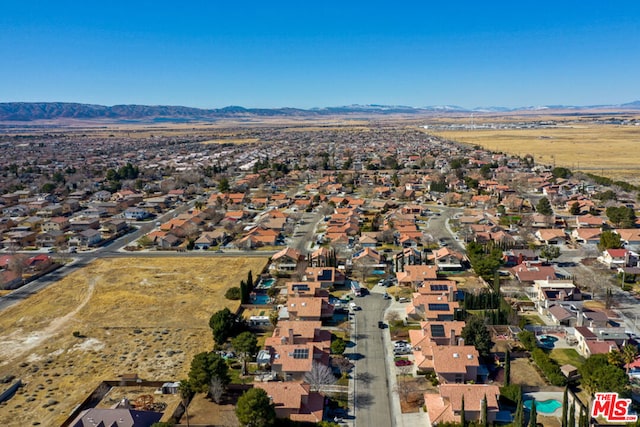 birds eye view of property with a mountain view