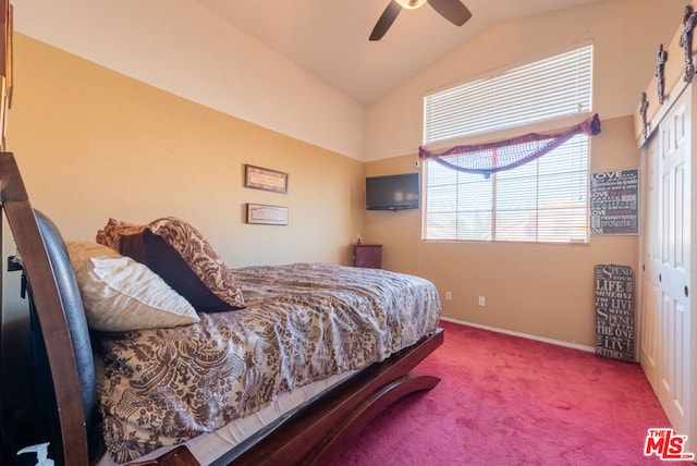 carpeted bedroom featuring ceiling fan, lofted ceiling, and a closet