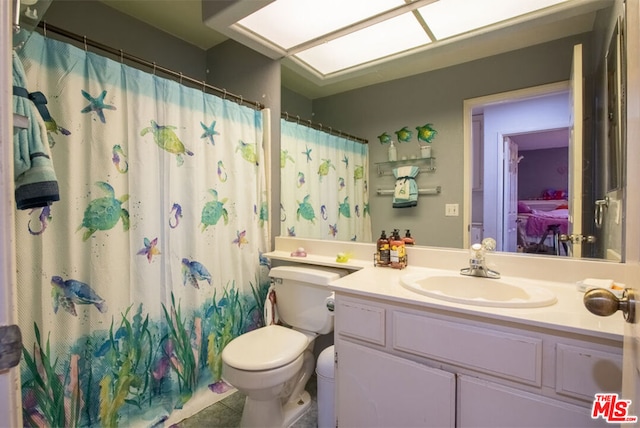 bathroom featuring vanity, toilet, and a shower with shower curtain