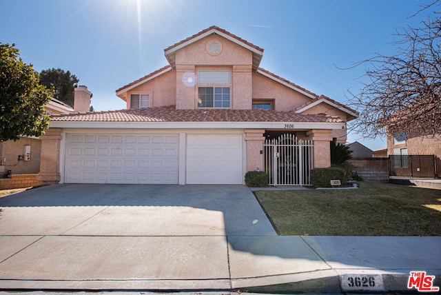 front of property with a garage and a front lawn