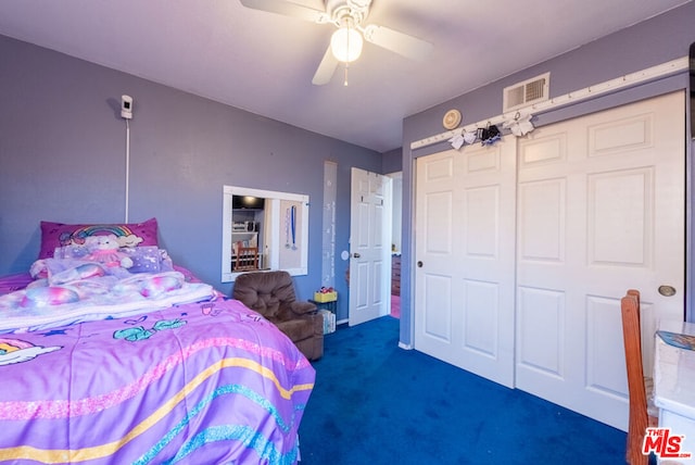 bedroom featuring ceiling fan, dark carpet, and a closet