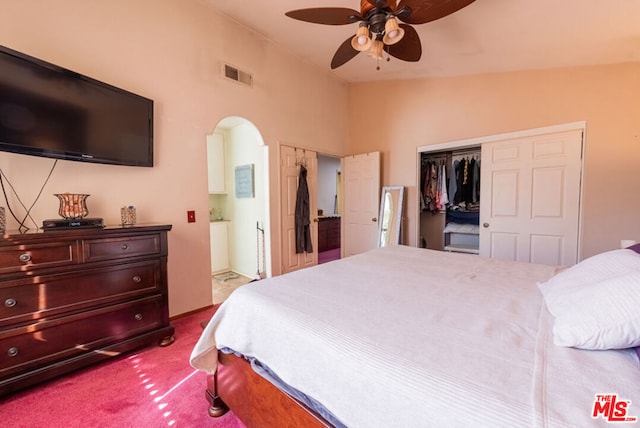 bedroom with vaulted ceiling, a closet, ceiling fan, and carpet flooring