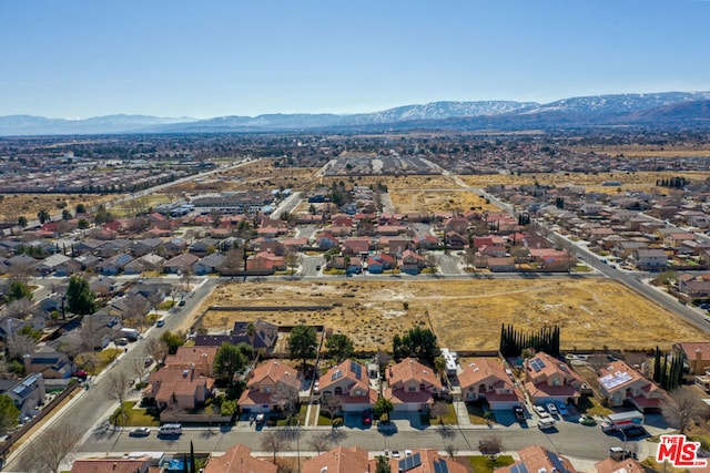 birds eye view of property with a mountain view