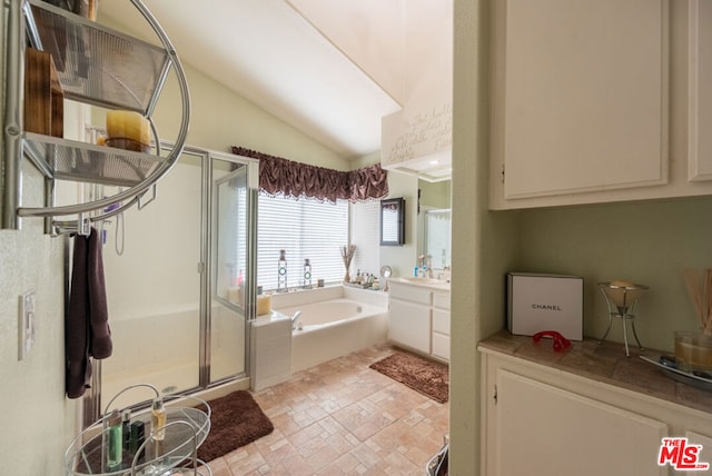 bathroom with plus walk in shower, vaulted ceiling, and vanity