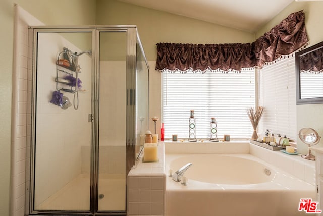 bathroom with vaulted ceiling and independent shower and bath