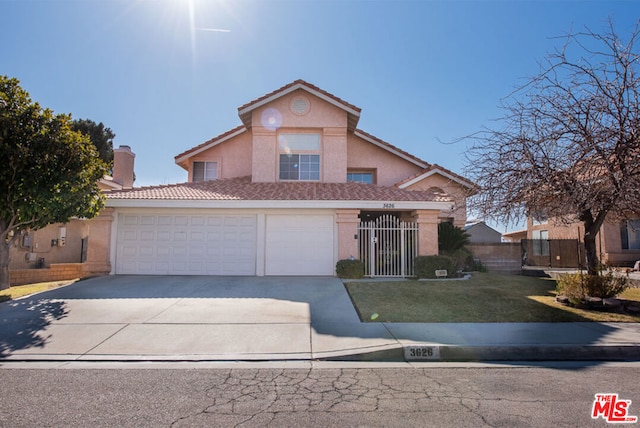 front of property featuring a garage and a front lawn