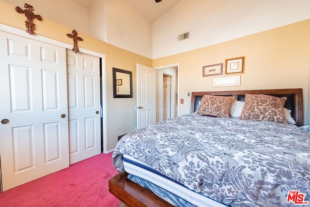 carpeted bedroom with high vaulted ceiling and a closet