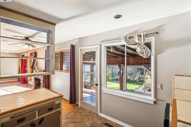 doorway with ceiling fan