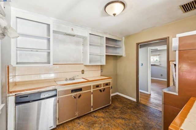 kitchen featuring tasteful backsplash, sink, tile countertops, and stainless steel dishwasher