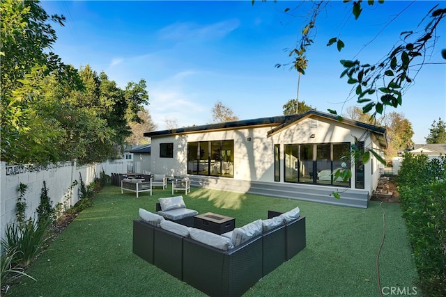 rear view of property featuring a yard and outdoor lounge area