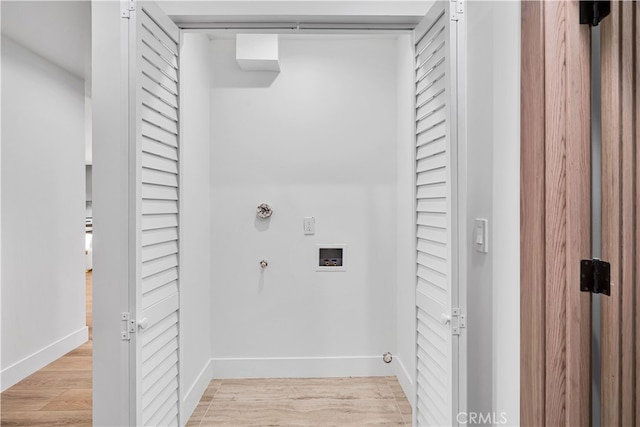 washroom with washer hookup, hookup for a gas dryer, and light wood-type flooring