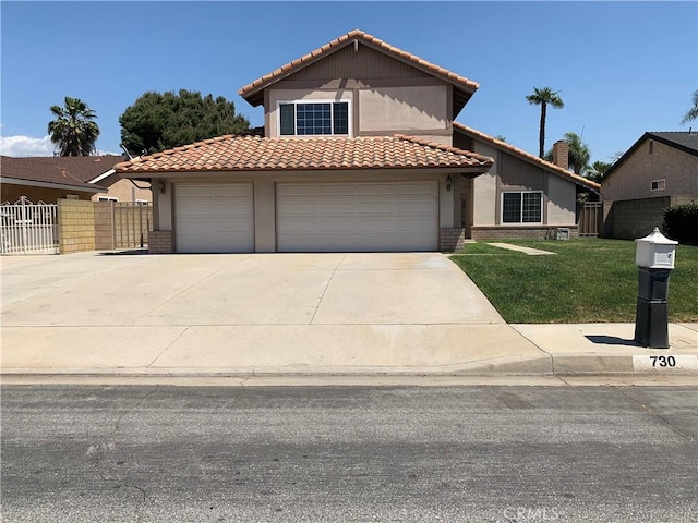 view of front of property featuring a garage and a front yard