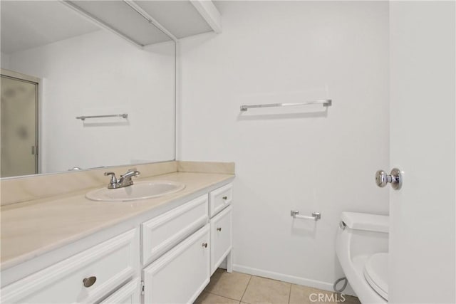 bathroom with vanity, toilet, baseboards, tile patterned floors, and a shower stall