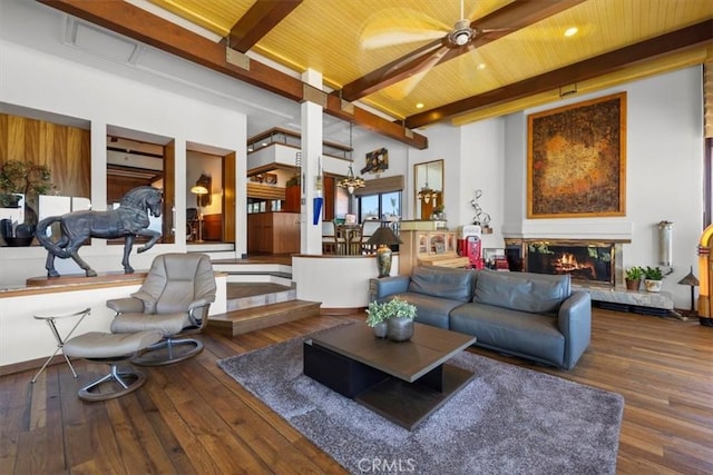 living room featuring beam ceiling, wood-type flooring, wooden ceiling, and a premium fireplace