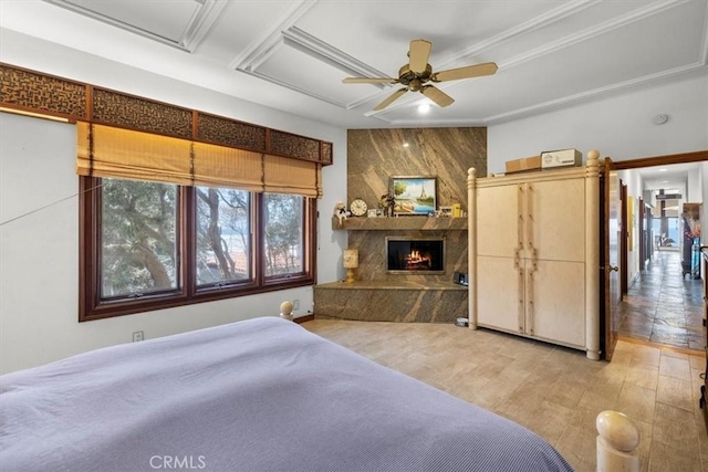 bedroom featuring a premium fireplace and light hardwood / wood-style floors