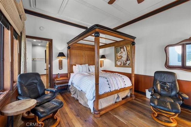 bedroom featuring crown molding, dark hardwood / wood-style floors, and ceiling fan