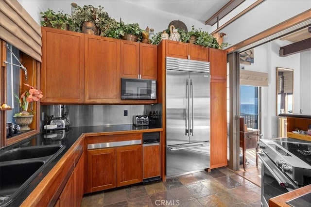 kitchen featuring high end appliances and sink