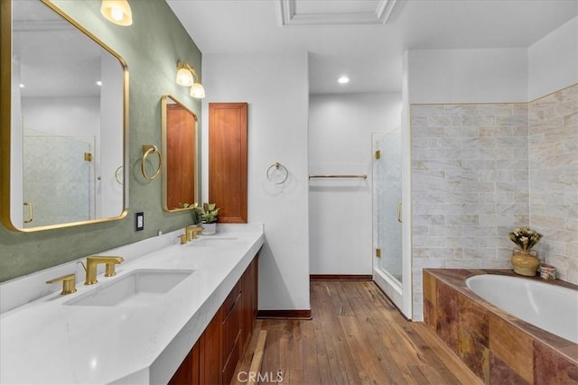 bathroom featuring vanity, separate shower and tub, and hardwood / wood-style floors