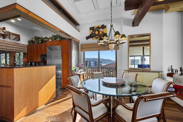 dining area featuring a mountain view, a chandelier, and dark hardwood / wood-style flooring