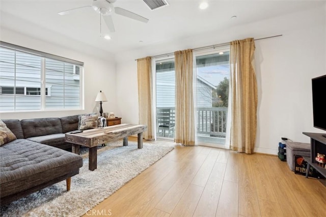 living room with ceiling fan and light hardwood / wood-style floors