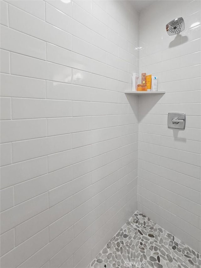 bathroom with a tile shower