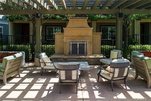 view of patio / terrace featuring an outdoor living space with a fireplace and a pergola