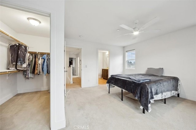 carpeted bedroom featuring ceiling fan and ensuite bathroom